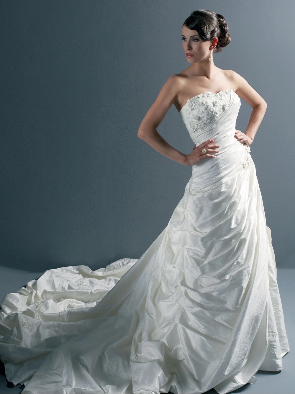 Size 2 petite wedding dress- never worn. Includes bustle and bra cups